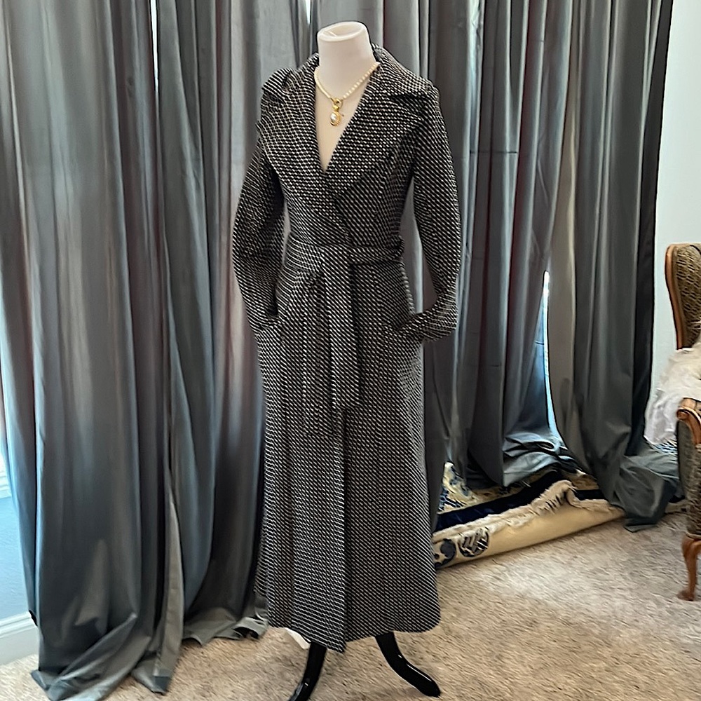 Full length princess cut wool coat with hood, pockets and set in tie belt.